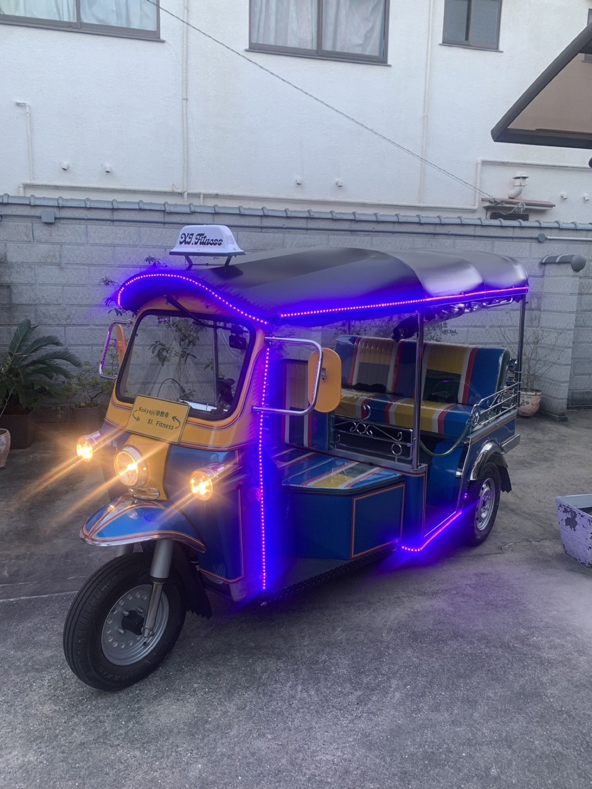 KariTuku tuk-tuk lit up at night in Osaka